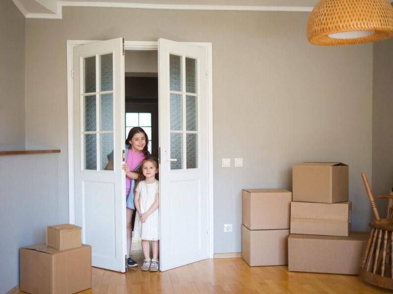 children-look-into-its-new-home-moving-to-apartment-boxes-in-house-1-1-pe7ens5euoxnfw6weepyx4ifht8bszjd5mhfpgym9s